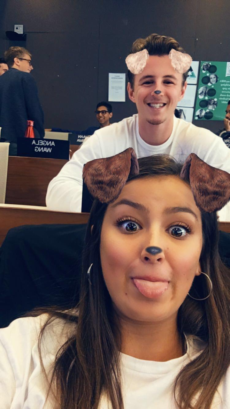 Mary and Hunter in an Ivey lecture hall, pulling faces behind a dog-ears photo filter.
